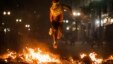 A demonstrator jumps over trash set afire during protests against poor public services, police violence and government corruption, in Sao Paulo, Brazil, June 18, 2013. 