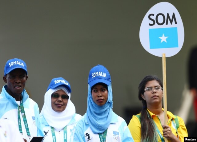 Mohamed Daud Mohamed, left, and Maryam Nuh Muse, second from right, are pictured with another member of their contingent during team-welcoming ceremonies for the 2016 Rio Olympics in Rio de Janeiro, Brazil, Aug. 4, 2016.