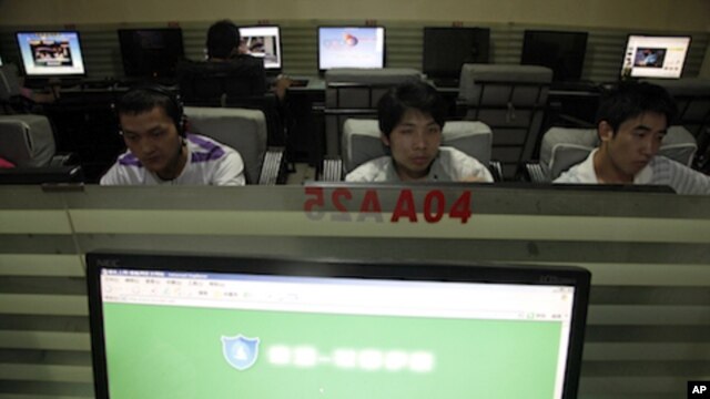 In this photo taken, July 14, 2010, Chinese men use computers at an internet cafe in Beijing, China. China's Twitter-like microblogs are facing new restrictions by the government.