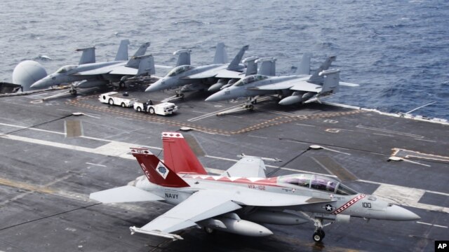 A U.S. Navy F/A-18 Super Hornet lands the deck of U.S. aircraft carrier USS George Washington during joint military drills between the U.S. and South Korea in the Yellow Sea, southwest of Seoul, June 24, 2012.
