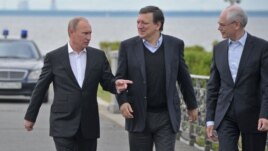 Russian President Vladimir Putin, left, European Commission President Jose Manuel Barroso, center, and European Council President Herman Van Rompuy walk during the Russia EU Summit outside St.Petersburg, Russia, Sunday, June 3, 2012. 