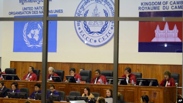 File photo of the Extraordinary Chambers in the Courts of Cambodia, court officers of the U.N.-backed war crimes tribunal are seen through windows during a hearing of former Khmer Rouge top leaders in Phnom Penh, file photo.