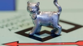 The newest Monopoly token, a cat, rests on the game board at Hasbro Inc. headquarters, in Pawtucket, R.I., Tuesday, Feb. 5, 2013.