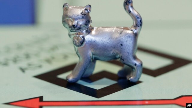 The newest Monopoly token, a cat, rests on the game board at Hasbro Inc. headquarters, in Pawtucket, R.I., Tuesday, Feb. 5, 2013.