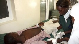 Nurses attend to a victim of the clashes between the pastoralists and farmers within the Tana Delta region, at the Malindi District hospital, Kenya, September 7, 2012. 