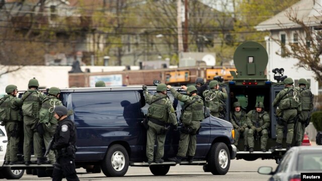 Law enforcement officers in tactical gear during search for Boston bombing suspect Dzhokar Tsarnaev, who was captured in Watertown, Massachusetts, April 19, 2013.