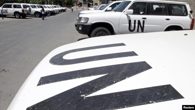 Vehicles belonging to United Nations observers are parked in front of a hotel in Damascus July 2, 2012. 