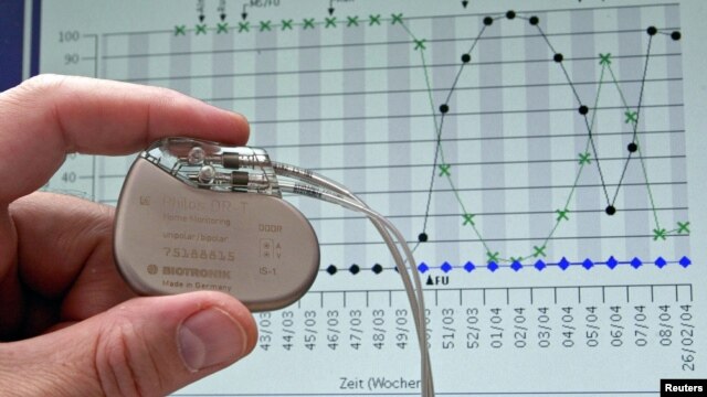 A pacemaker is shown against the backdrop of a cardiological graph in Potsdam, Germany, February 26, 2004.