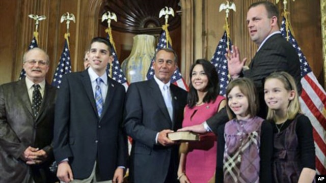 House Speaker John Boehner of Ohio, center, performs the ceremonial swearing-in of Tea Party favorite Rep. Jon Runyan, R-N.J., in Washington, January 5, 2011