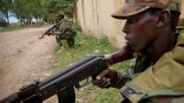 Somali National Army soldiers serving with the AU Mission in Somalia hold defensive positions in the town of Afgoye