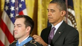 President Barack Obama bestows the Medal of Honor on retired Staff Sgt. Clinton Romesha for conspicuous gallantry, Feb. 11, 2013,  in the East Room of the White House. Romesha will be a guest at the State of The Union Address.