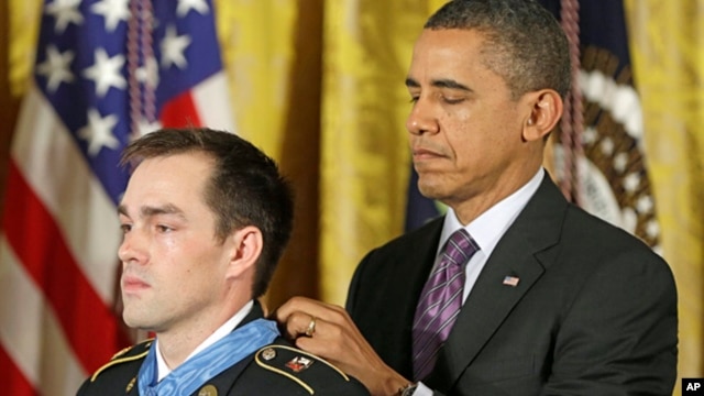 President Barack Obama bestows the Medal of Honor on retired Staff Sgt. Clinton Romesha for conspicuous gallantry, Feb. 11, 2013,  in the East Room of the White House. Romesha will be a guest at the State of The Union Address.