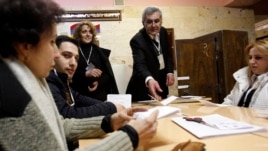 Election officials count ballots after polls closed at a polling station in Yerevan, February 18, 2013. Armenian President Serzh Sarksyan will secure a new five-year term in a election on Monday, an exit poll showed after a vote overshadowed by a lack of 