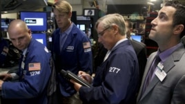 Traders work on the floor at the New York Stock Exchange in New York, Oct. 31, 2012. 