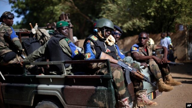 The Malian army patrol the streets of Gao, Northern Mali, Sunday Nov. 24, 2013. Malians have begun voting in legislative elections amid heavy security highlighting fears the poll could be sabotaged by rebel attacks. (AP Photo/Jerome Delay)