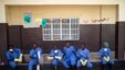 FILE - Health workers rest outside a quarantine zone at a Red Cross facility in the town of Koidu, Kono district in Eastern Sierra Leone, Dec. 19, 2014. 