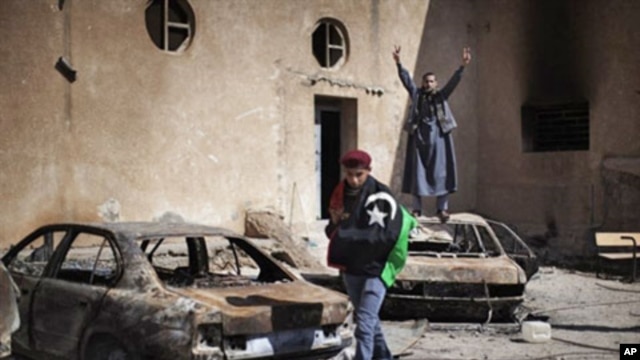 Libyan anti-regime demonstrators at a burned police station in Tobruk, February 25, 2011