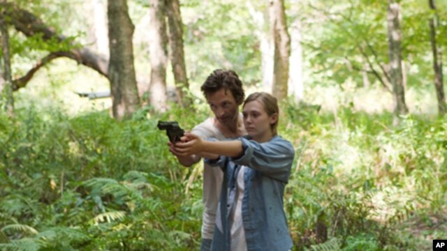 John Hawkes portrays a cult leader and Elizabeth Olsen is the young woman who escapes him in “Martha Marcy May Marlene.”