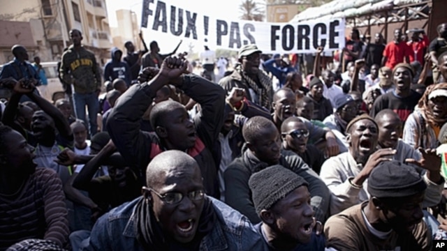 Senegalese anti-government youth rally against President Wade in the capital Dakar. Members of a Senegalese anti-government youth movement Y En A Marre (We're Fed Up) chant slogans during a rally against President Abdoulaye Wade in the capital Dakar, Janu