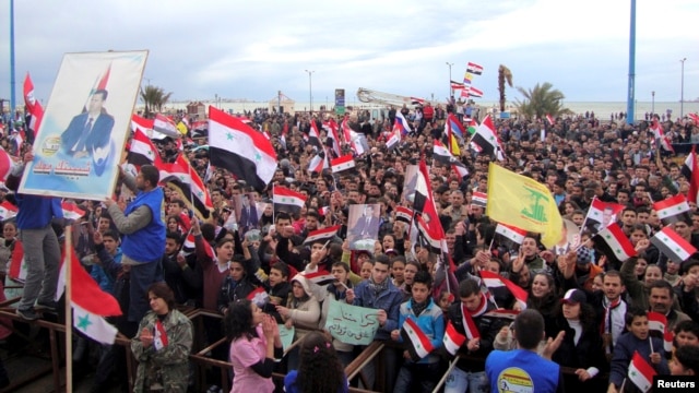 Supporters of Syria's President Bashar al-Assad attend a rally in the northern port city of Tartous, Jan. 12, 2012.