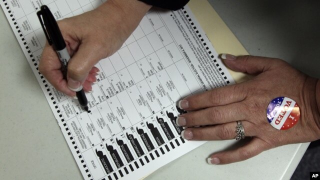 A voter, who did not wish to be identified, votes on Election Day at the Holland Land Office Museum in Batavia, N.Y., Tuesday, Nov. 6, 2012.