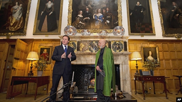 British Prime Minister David Cameron, left, speaks during a press conference with President Hamid Karzai of Afghanistan at the Prime Minister's country residence of Chequers, at Ellesborough west of London, January 28, 2012.