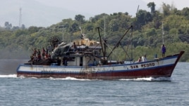 Filipino fishermen wave from a fishing boat bound to fish near Scarborough Shoal in Masinloc, Zambales May 10, 2012. 