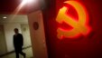 A trainee walks pass a communist party logo as he attends a training course at the communist party school called China Executive Leadership Academy, Sept. 2012.