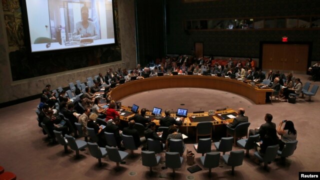 FILE - Valerie Amos, United Nations Under-Secretary- General for Humanitarian Affairs and Emergency Relief Coordinator (seen on screen) briefs a U.N. Security Council meeting on the situation in the Middle East, at U.N. headquarters in New York, July 31, 2014. 