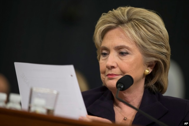 FILE - Democratic presidential candidate, former Secretary of State Hillary Rodham Clinton looks at an email sent by Ambassador Chris Stevens during her testimony before the House Benghazi Committee, Oct. 22, 2015, on Capitol Hill in Washington.