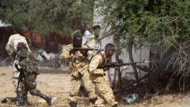 Somali government soldiers open fire during an ambush by al-Shabab rebels on the outskirts of Elasha town, Somalia, May 29, 2012.