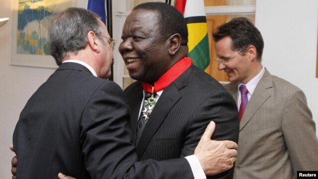 Zimbabwean Prime Minister Morgan Tsvangirai (C) is congratulated by the French Ambassador to Zimbabwe Francois Ponge (L) and his deputy Dietmar Petrausch after receiving the Commander of the Legion of Honor in Harare, Zimbabwe, August 21, 2012.