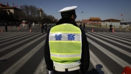 Chinese police wait for the arrival of delegates for a session of the National People's Congress outside the Great Hall of the People in Beijing, China, March 11, 2012. 