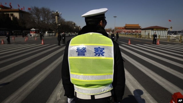 Chinese police wait for the arrival of delegates for a session of the National People's Congress outside the Great Hall of the People in Beijing, China, March 11, 2012. 