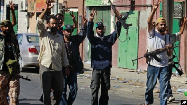 Libyan rebel fighters celebrate after taking partial control of the coastal town of Zawiya, 50 km (30 miles) west of Tripoli, August 14, 2011.