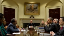 President Barack Obama drops by a meeting with President Hassan Sheikh Mohamud of Somalia and Deputy National Security Advisor Denis McDonough in the Roosevelt Room of the White House, Jan. 17, 2013.