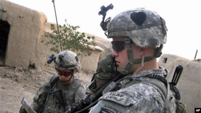 Soldiers from the U.S. 101st Airborne Division's 1st Battalion search a home in Senjeray, Kandahar province, Afghanistan, 7 Sept. 2010.