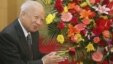 Cambodian King Norodom Sihanouk stands beside flowers given by the Chinese government during a meeting with Chinese State Councilor Dai Bingguo (not seen) in Beijing, October 30, 2006.