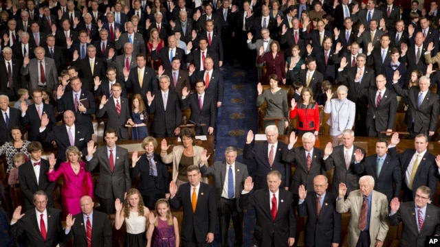 Members of the 113th U.S. Congress, many accompanied by family members, take the oath of office in the House of Representatives chamber on Capitol Hill in Washington, Thursday, Jan. 3, 2013.