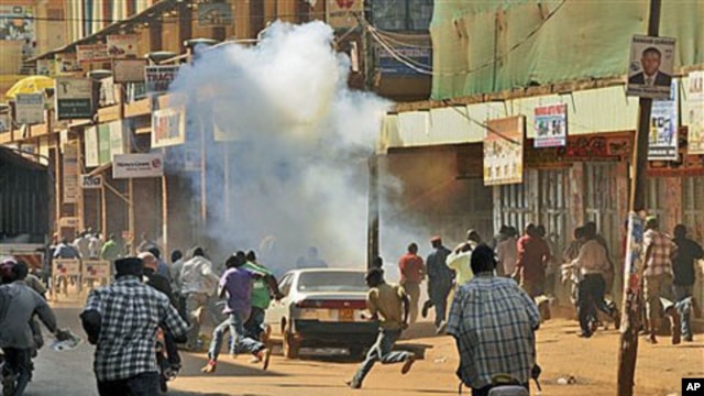 Ugandan protesters run after police fired tear gas during a demonstration against high food and fuel prices, in Kampala, Uganda, October 17, 2011.