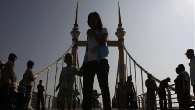 Cambodians walk on a bridge (now removed) on which hundreds of people stampeded during a water festival on Nov. 22, 2010.