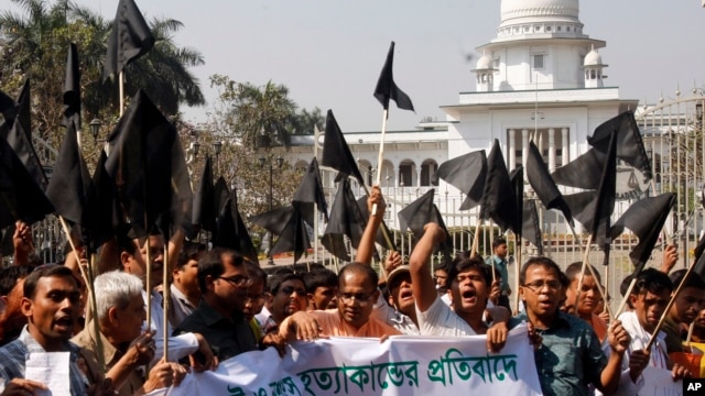 Bangladeshi Hindus wave black flags as they march through a street to protest against alleged attacks by Jamaat-e-Islami activists in Dhaka, Bangladesh, March 2, 2013. 