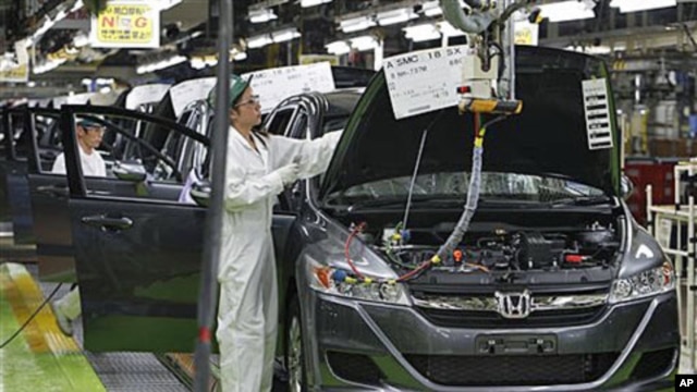 Workers give a final check on the Honda Accord Tourer at Honda Motor Co.'s Saitama Factory in Sayama, north of Tokyo, April 18, 2011