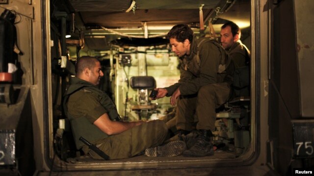 Israeli soldiers in an Armoured Personnel Carrier at a staging area outside the northern Gaza Strip, Nov. 21, 2012.