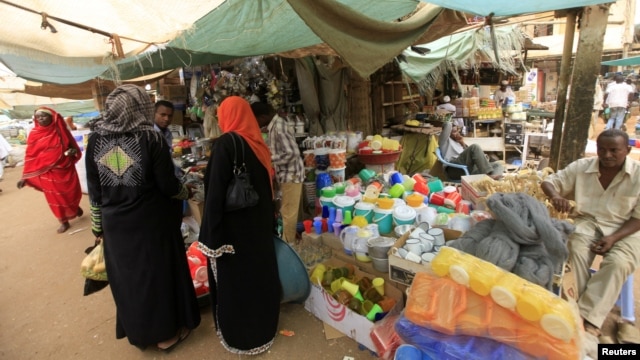Women wait to buy things for Ramadan at a central food market in Khartoum, Sudan, July 18, 2012. 