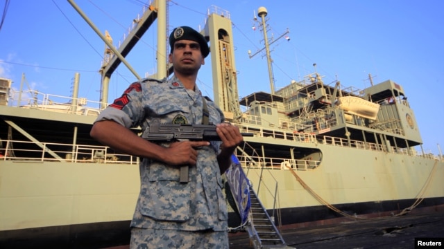 An Iranian soldier stands guard near Iranian Navy helicopter carrier Kharg at Port Sudan at the Red Sea State, October 31, 2012.