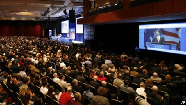Attendees listen to Republican Ron Paul speak at the 38th annual Conservative Political Action Conference (CPAC) in Washington February 10, 2011.