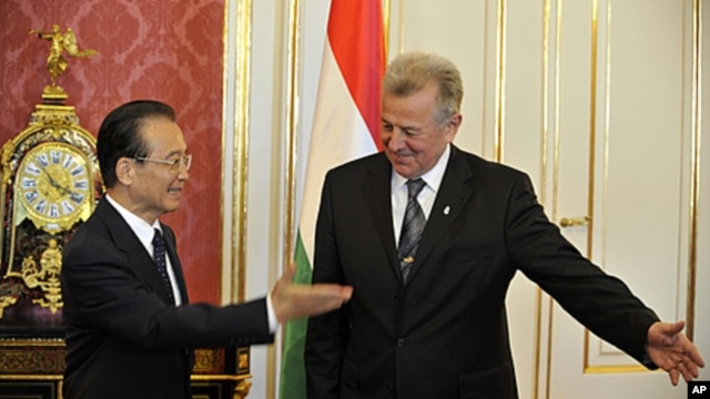 Chinese Prime Minister Wen Jiabao and Hungarian President Pal Schmitt, greet each other before meeting in Budapest, Hungary, June 25, 2011