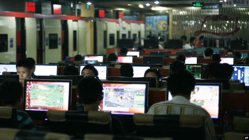 FILE - Customers surf the Internet at an Internet cafe in Beijing, China.