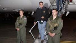 U.S. Defense Secretary Leon Panetta, center,  steps off his jet after arriving at Yokota Air Base on the outskirts of Tokyo, Japan, Sunday, Sept. 16, 2012. 